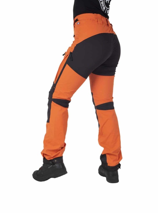 Orange Nokko outdoor pants for women shown from the back on the model