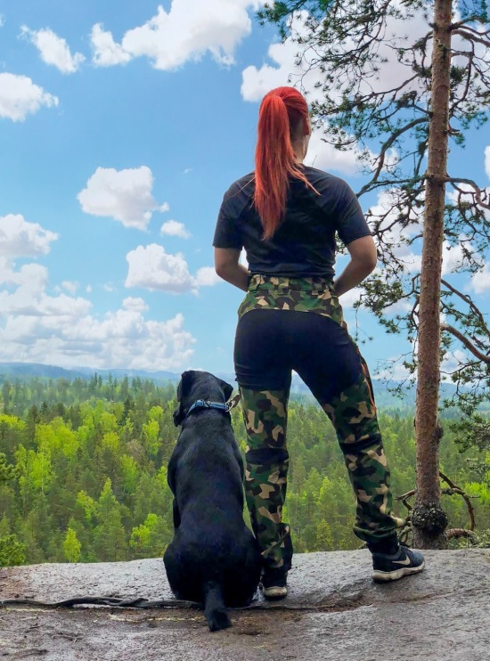 Nokko Camo outdoor pants for women on a model on a rock