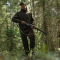 Karelia Forest Green hunting trousers on a model in the forest
